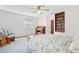 Comfortable bedroom featuring a decorative ceiling fan, desk, and built-in shelving at 2008 Tweed Ct, Leesburg, FL 34788