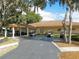 Exterior view of clubhouse parking area with multiple golf carts at 2008 Tweed Ct, Leesburg, FL 34788