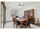 Dining room with a wooden table, black chairs, and a hutch for elegant gatherings at 2008 Tweed Ct, Leesburg, FL 34788