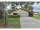 Charming single-story home with a well-maintained lawn and beautiful landscaping at 2008 Tweed Ct, Leesburg, FL 34788