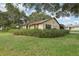 Exterior view of a single-story home with an attached garage and well-maintained lawn at 2008 Tweed Ct, Leesburg, FL 34788