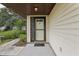 Welcoming front entryway with a decorative glass-accented door and neutral siding at 2008 Tweed Ct, Leesburg, FL 34788