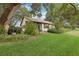 Charming home with well-maintained lawn, mature trees, shrubs, and exterior siding at 2008 Tweed Ct, Leesburg, FL 34788