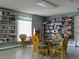 Interior view of game room with shelves, games, table, chairs, and window at 2008 Tweed Ct, Leesburg, FL 34788