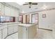 Spacious kitchen with island, light cabinets, and a seamless transition to the dining area at 2008 Tweed Ct, Leesburg, FL 34788