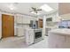Well-lit kitchen featuring stainless steel appliances, white cabinets, and tiled flooring at 2008 Tweed Ct, Leesburg, FL 34788