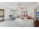 Bright living room with neutral carpeting, a ceiling fan, and views to the outside at 2008 Tweed Ct, Leesburg, FL 34788