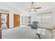 Bright living room featuring a ceiling fan and comfortable seating area with neutral carpeting at 2008 Tweed Ct, Leesburg, FL 34788