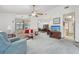 Spacious living room with ceiling fan, carpeting, and open layout to the dining area at 2008 Tweed Ct, Leesburg, FL 34788