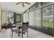Cozy sunroom with a glass-top table, seating, and large windows overlooking the yard at 2008 Tweed Ct, Leesburg, FL 34788