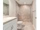 Stylish bathroom featuring tiled walk-in shower and white vanity with ample storage space at 20443 Sw Rainbow Lakes Blvd, Dunnellon, FL 34431