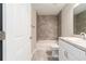 Bright bathroom featuring a tub/shower combo, toilet, and vanity with storage at 20443 Sw Rainbow Lakes Blvd, Dunnellon, FL 34431