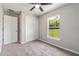 Comfortable bedroom with a window view, ceiling fan, and closet at 20443 Sw Rainbow Lakes Blvd, Dunnellon, FL 34431