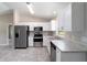 Modern kitchen featuring stainless steel appliances, white cabinets, and ample counter space at 20443 Sw Rainbow Lakes Blvd, Dunnellon, FL 34431