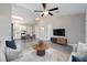 Open-concept living room and dining area with vaulted ceilings, ceiling fan, and neutral décor at 20443 Sw Rainbow Lakes Blvd, Dunnellon, FL 34431