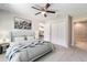 Serene main bedroom with ceiling fan, closet, and ensuite bathroom, ideal for relaxation at 20443 Sw Rainbow Lakes Blvd, Dunnellon, FL 34431