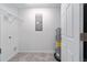 Clean utility room with tile flooring, water heater, electrical panel, and wire shelving for efficient storage at 20443 Sw Rainbow Lakes Blvd, Dunnellon, FL 34431