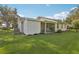 Exterior of home with large green backyard and covered patio area at 2208 Orkney Dr, Leesburg, FL 34788