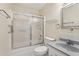 Bathroom featuring a shower-tub combo with glass doors and a single sink vanity at 2208 Orkney Dr, Leesburg, FL 34788
