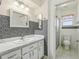 Bathroom featuring white marble countertops, mosaic tile, and bright lighting for a luxurious feel at 2208 Orkney Dr, Leesburg, FL 34788