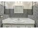 Bathroom showcasing a marble countertop vanity and mosaic tile walls for a modern design at 2208 Orkney Dr, Leesburg, FL 34788