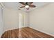 Bright bedroom with a ceiling fan, beautiful wood floors, and closet space at 2208 Orkney Dr, Leesburg, FL 34788