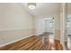 Dining room features modern lighting fixture and wood floors at 2208 Orkney Dr, Leesburg, FL 34788