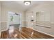 Dining room leads to kitchen featuring modern lighting and wood floors at 2208 Orkney Dr, Leesburg, FL 34788
