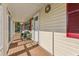 Charming front porch with brick flooring, seating, and a welcoming entrance to the home at 2208 Orkney Dr, Leesburg, FL 34788
