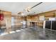 Spacious garage featuring work bench, storage, and door to the house at 2208 Orkney Dr, Leesburg, FL 34788