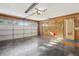 Bright two car garage featuring an insulated garage door and storage at 2208 Orkney Dr, Leesburg, FL 34788