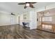 A living room with wood floors, desk, ceiling fan, and neutral walls create a peaceful living space at 2208 Orkney Dr, Leesburg, FL 34788