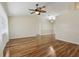 Spacious living room featuring wood floors, ceiling fan, and vaulted ceiling at 2208 Orkney Dr, Leesburg, FL 34788