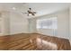 Spacious living room with hardwood floors, ceiling fan, and plenty of natural light at 2208 Orkney Dr, Leesburg, FL 34788