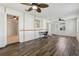 A spacious living room featuring wood floors, ceiling fans, and bright natural light at 2208 Orkney Dr, Leesburg, FL 34788