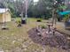 Backyard featuring a landscaped garden area with decorative elements and peaceful outdoor seating at 22736 Sw 117Th St, Dunnellon, FL 34431