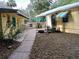 Charming backyard showcasing a walkway, lush greenery, and outdoor seating perfect for enjoying the serene environment at 22736 Sw 117Th St, Dunnellon, FL 34431