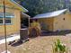 View of backyard, showing a yard with a storage building and some landscaping detail at 22736 Sw 117Th St, Dunnellon, FL 34431