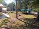 Serene backyard featuring mature trees, a shaded seating area, and lush green space at 22736 Sw 117Th St, Dunnellon, FL 34431
