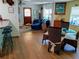 Inviting dining area featuring woven chairs and view into a living room with a blue sofa at 22736 Sw 117Th St, Dunnellon, FL 34431
