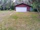 Detached two-car garage surrounded by lush greenery, offering ample space for parking and storage at 22736 Sw 117Th St, Dunnellon, FL 34431