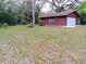 Detached two-car garage surrounded by mature trees and lush greenery, offering ample space for parking and storage at 22736 Sw 117Th St, Dunnellon, FL 34431