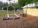 Inviting backyard garden featuring raised beds and lush greenery, creating a tranquil and picturesque outdoor space at 22736 Sw 117Th St, Dunnellon, FL 34431