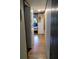 Hallway view showcasing laminate wood flooring with access to other rooms at 22736 Sw 117Th St, Dunnellon, FL 34431