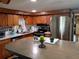 Bright kitchen with wooden cabinets, stainless steel appliances, marble countertops and large center island at 22736 Sw 117Th St, Dunnellon, FL 34431