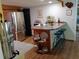 Galley kitchen boasts stainless steel appliances, a breakfast bar, and ample counter space, perfect for cooking and entertaining at 22736 Sw 117Th St, Dunnellon, FL 34431