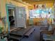 Inviting enclosed porch with seating, decor, and views, providing a comfortable transition between indoors and outdoors at 22736 Sw 117Th St, Dunnellon, FL 34431