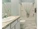 Bathroom features a granite countertop, white cabinetry, and a bathtub with shower at 2296 Sheehan St, The Villages, FL 32163