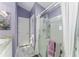 Bathroom featuring a glass shower, neutral-toned walls, granite counters, and tile floors at 2296 Sheehan St, The Villages, FL 32163