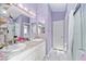 Bathroom featuring double sinks, a crystal chandelier, and a walk-in shower at 2296 Sheehan St, The Villages, FL 32163